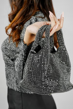 Woman holding the Stellar black crystal bucket bag for party wear