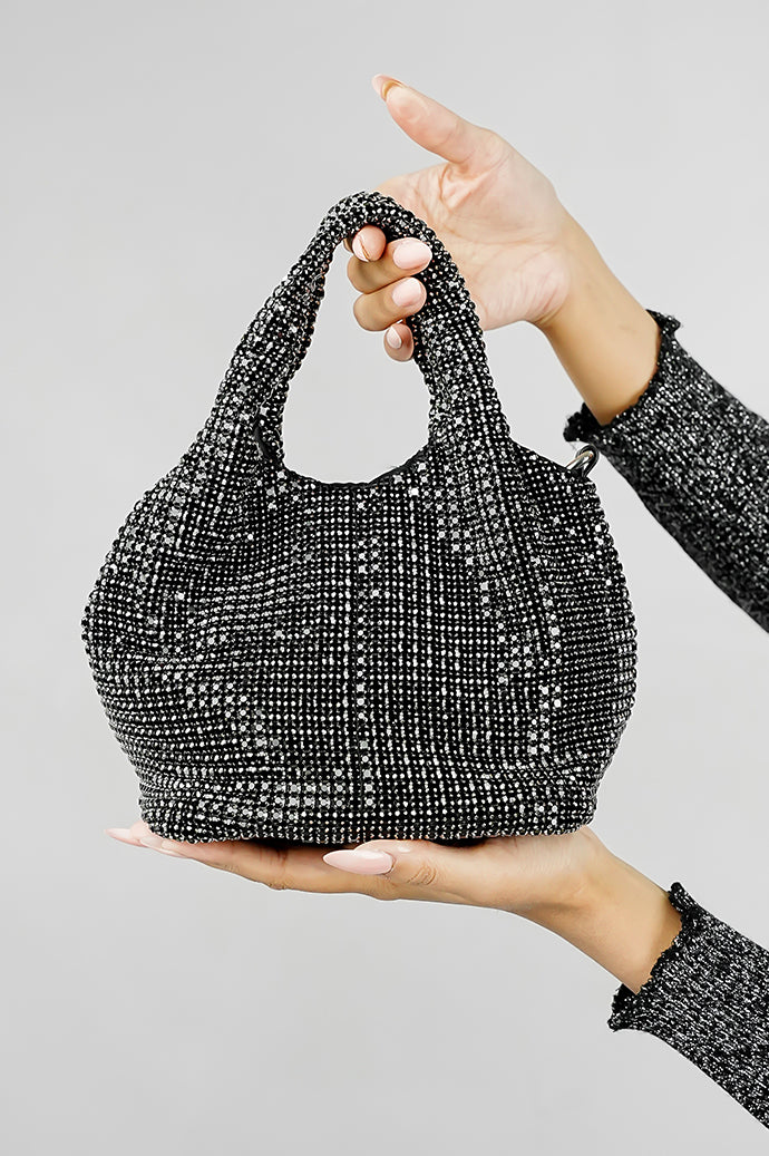 Stellar black crystal bucket bag held up on a grey background