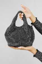 Stellar black crystal bucket bag held up on a grey background