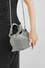 Silver crystal bucket bag with chain strap, side view