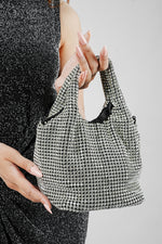 Stellar silver crystal bucket bag carried by the top handles