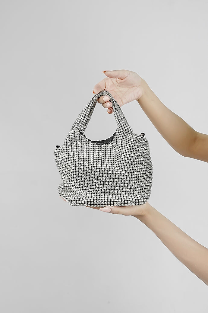 Stellar silver crystal bucket bag hanging from the arm