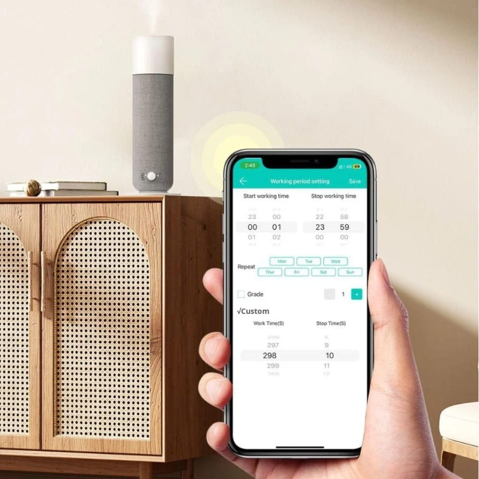 Phone showing the Textured Tower aroma diffuser app on a cabinet in a living room