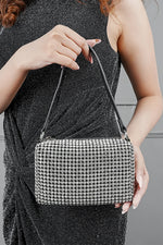 Woman holding the Wang Large silver bag at her waist