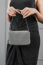 Wang Large silver sparkling bag styled with a black glitter dress