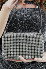 Close-up of the Wang Large silver sparkling rectangle bag held at the front