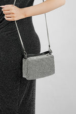 Wang Large silver sparkling bag on a long black strap, worn at the hip