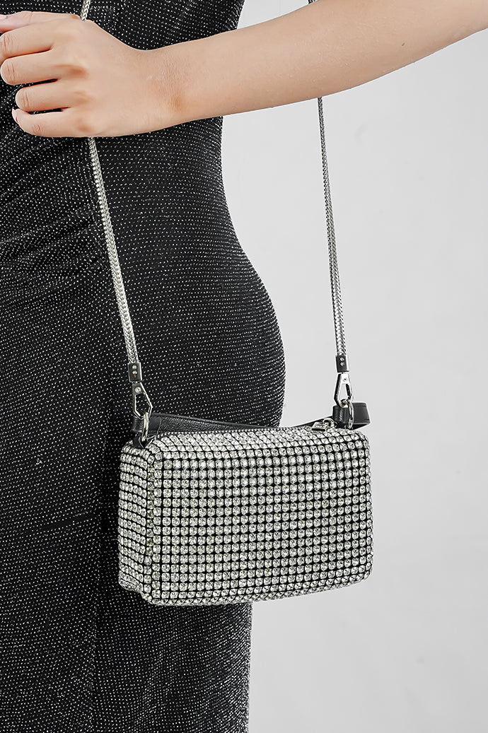 Wang Large silver bag worn crossbody with a black strap, side view