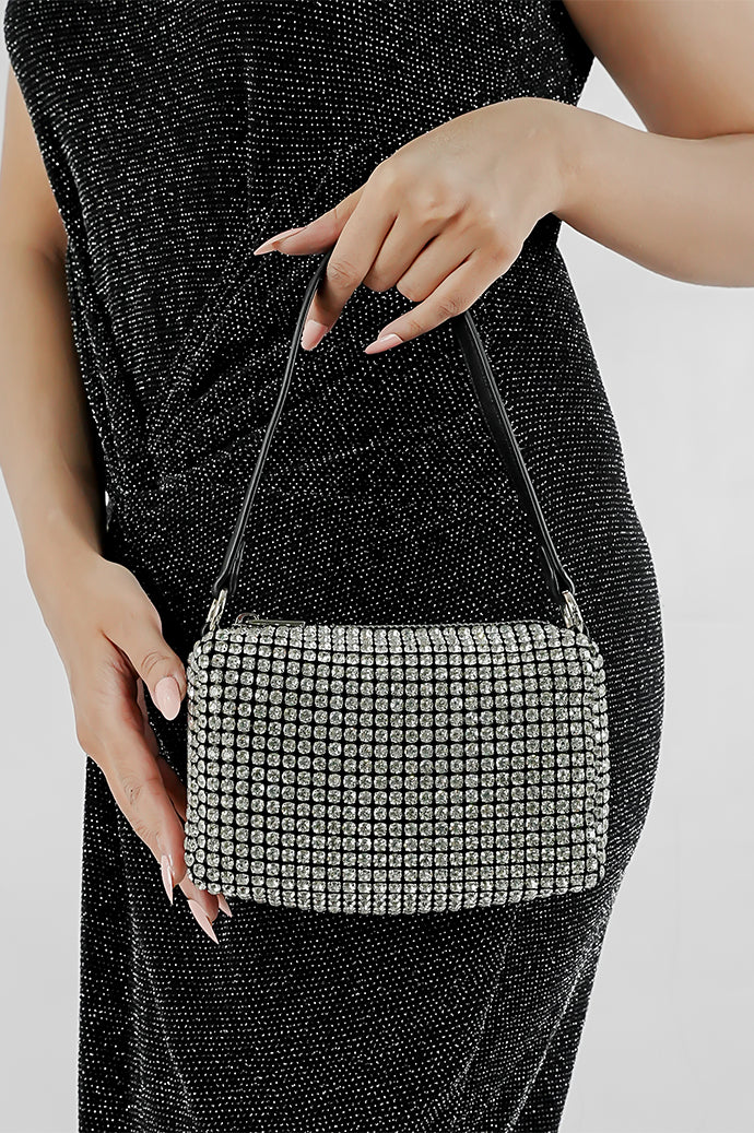 Wang Large silver sparkling rectangle bag with black strap held in hand, Future Style Pakistan