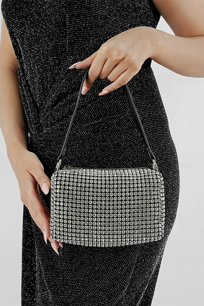 Wang Large silver sparkling rectangle bag with black strap held in hand, Future Style Pakistan
