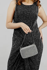 Wang Large silver bag held at the hip with the strap in hand