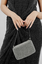 Wang Large silver sparkling bag held low in front with both hands