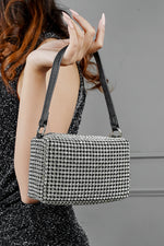 Wang Large silver bag with black strap worn on the shoulder, back view