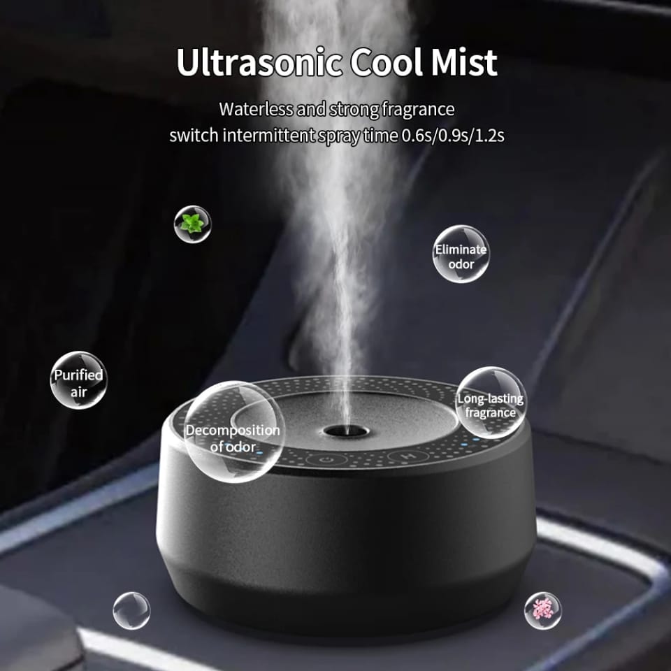 Waterless car aroma diffuser releasing a fine fragrance mist in a car